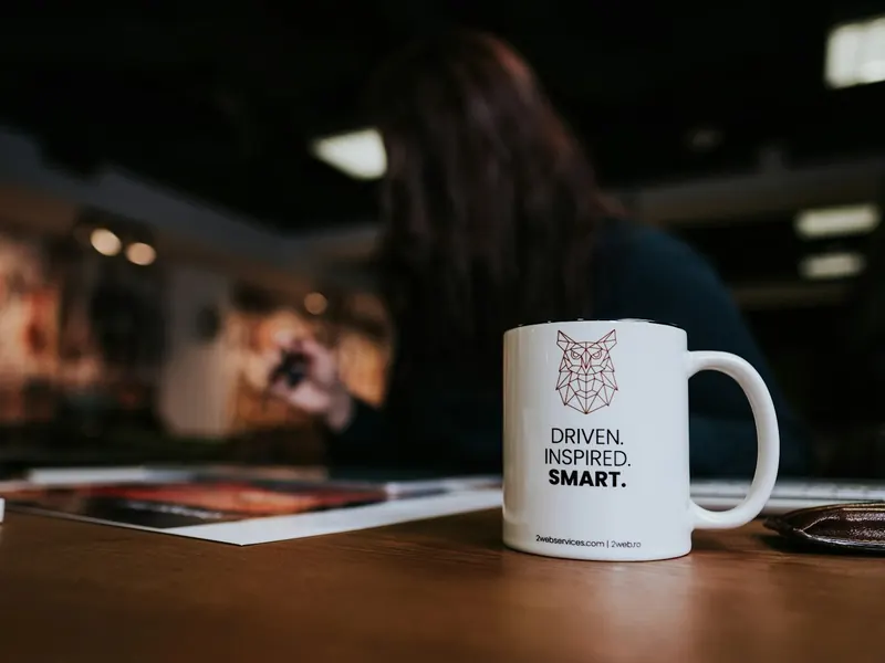 Taza de cerámica blanca con un logotipo impreso